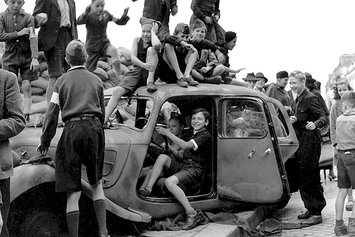 Children celebrating the liberation of Paris, France, 1944 by Lee Miller,
